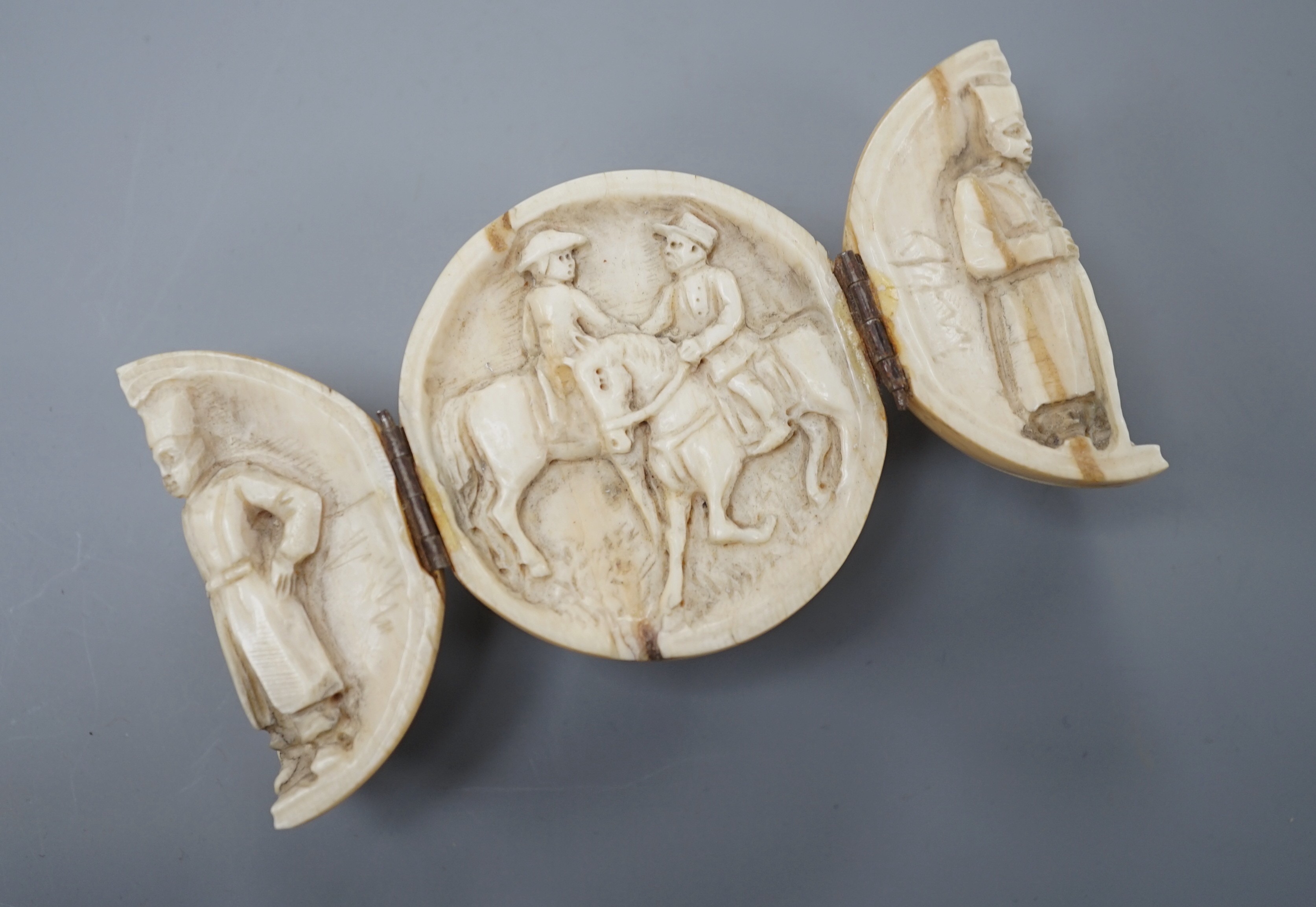 A 19th century Dieppe ivory globular triptych, possibly depicting Crimean war figures, 5.4cm diameter closed